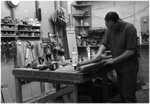 A craftsman making snooker table cushions by hand
