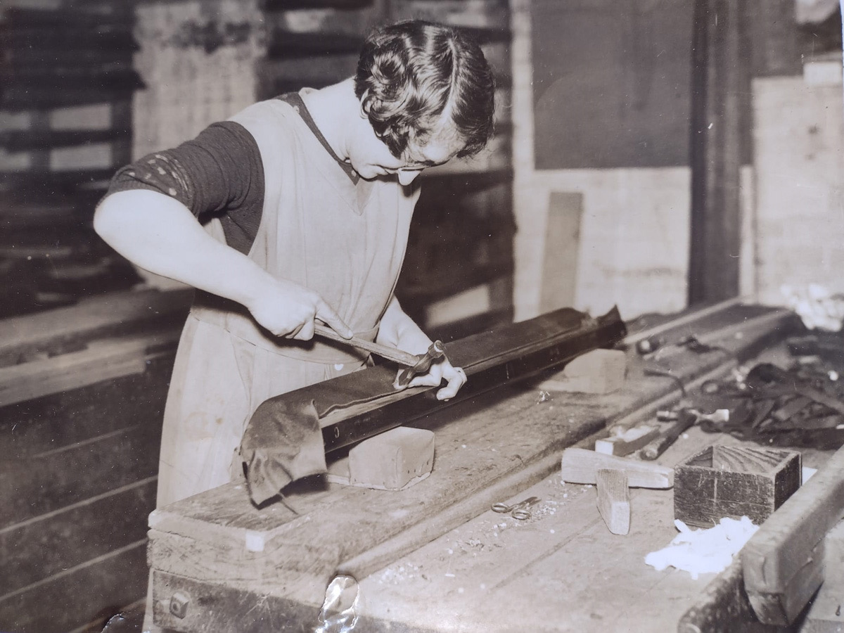 May Dean tacking cloth to a snooker table cushion at the E.J Riley works in the 1920s