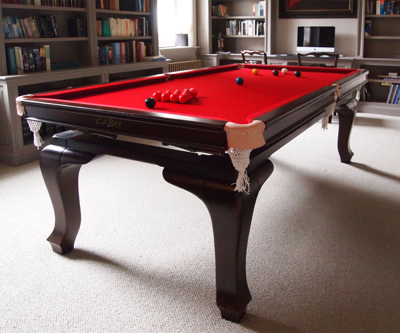 7ft E.J Riley Cabriole snooker dining table with red cloth in a library